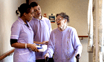 An older person with a nurse and assistant in a care home An older person with a nurse and assistant in a care home