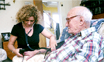 Care at home Care at home - medical professional takes blood pressure from older patient
